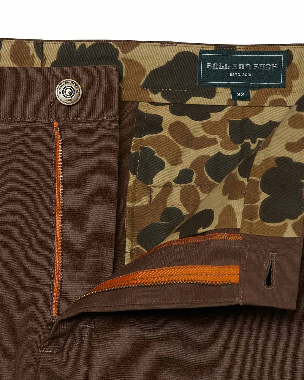 Brown pants with camouflage lining and brand label on a white background