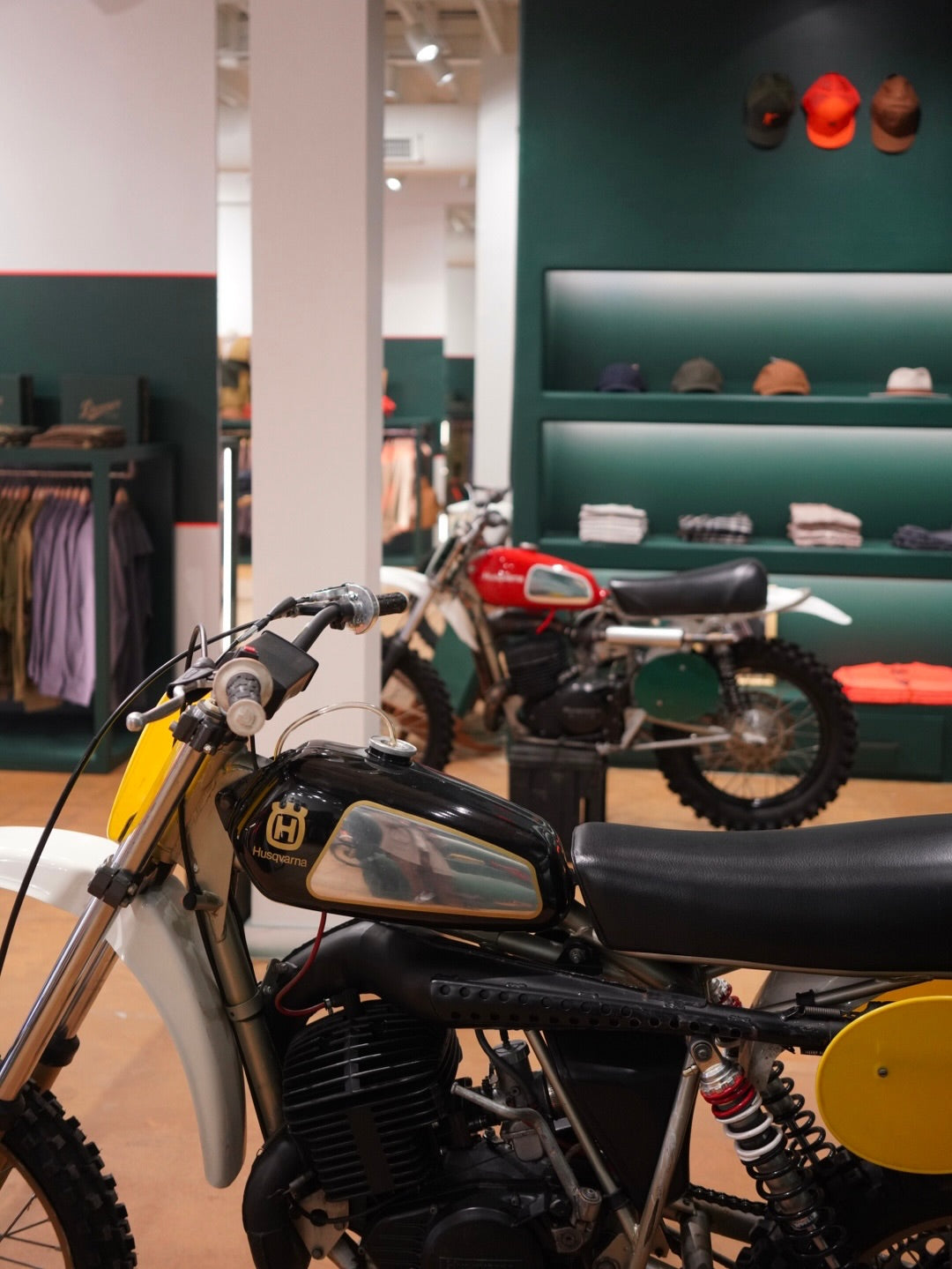 Vintage motorcycle on display in a store with shelves in the background